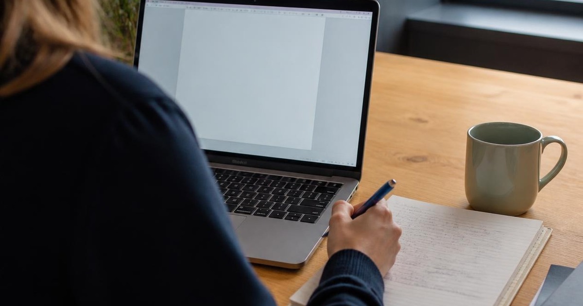 Business owner preparing a website brief with a laptop and notes