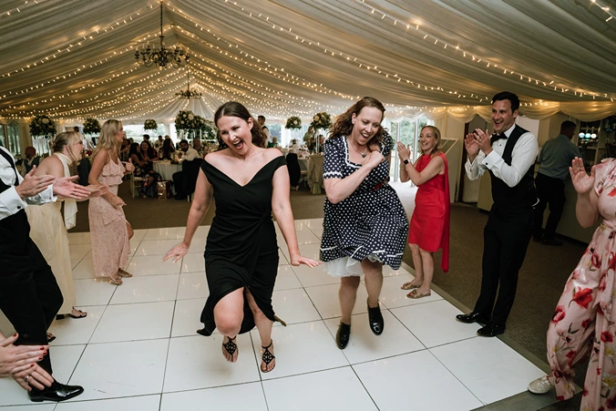 Guests dancing a lively ceilidh with our Bristol ceilidh band at a wedding