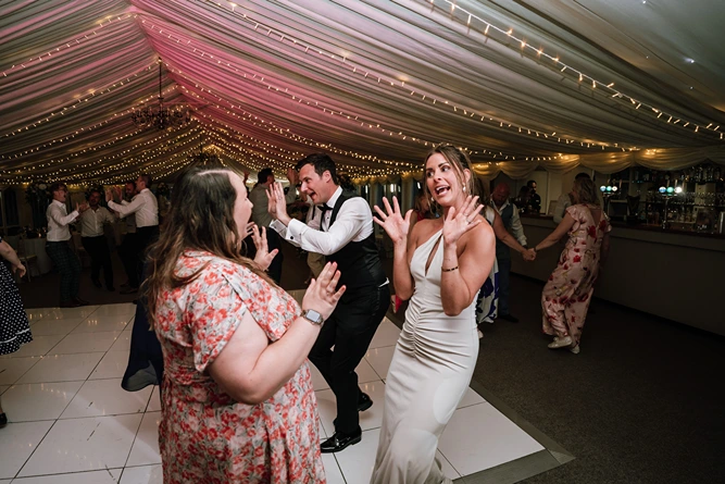 Students and guests enjoying the Oxford ceilidh band during a lively ball.
