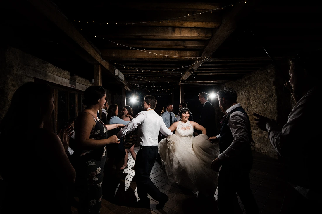 Kent ceilidh band leading traditional dances in a rustic barn venue.