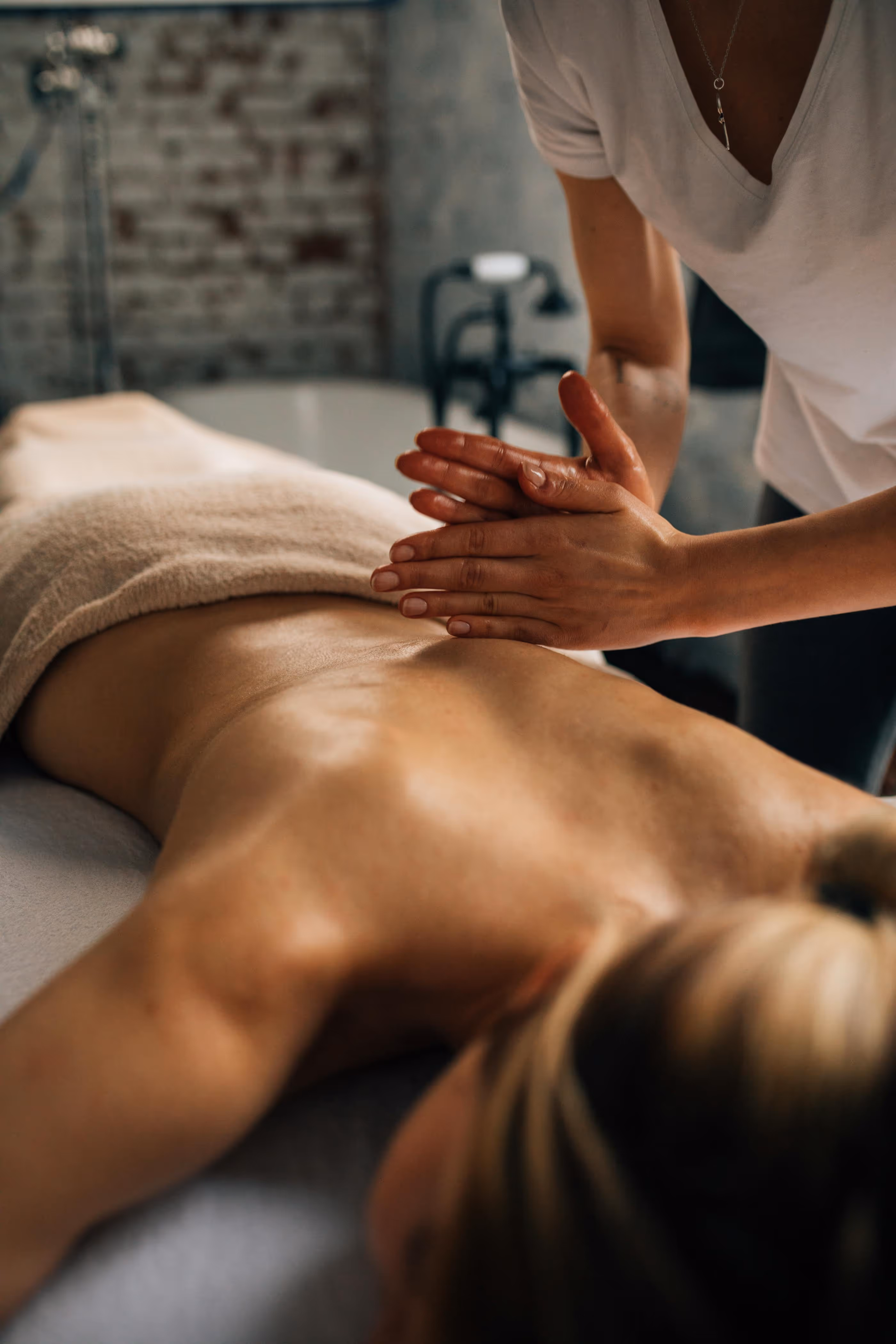 Massage therapist massaging a person's back