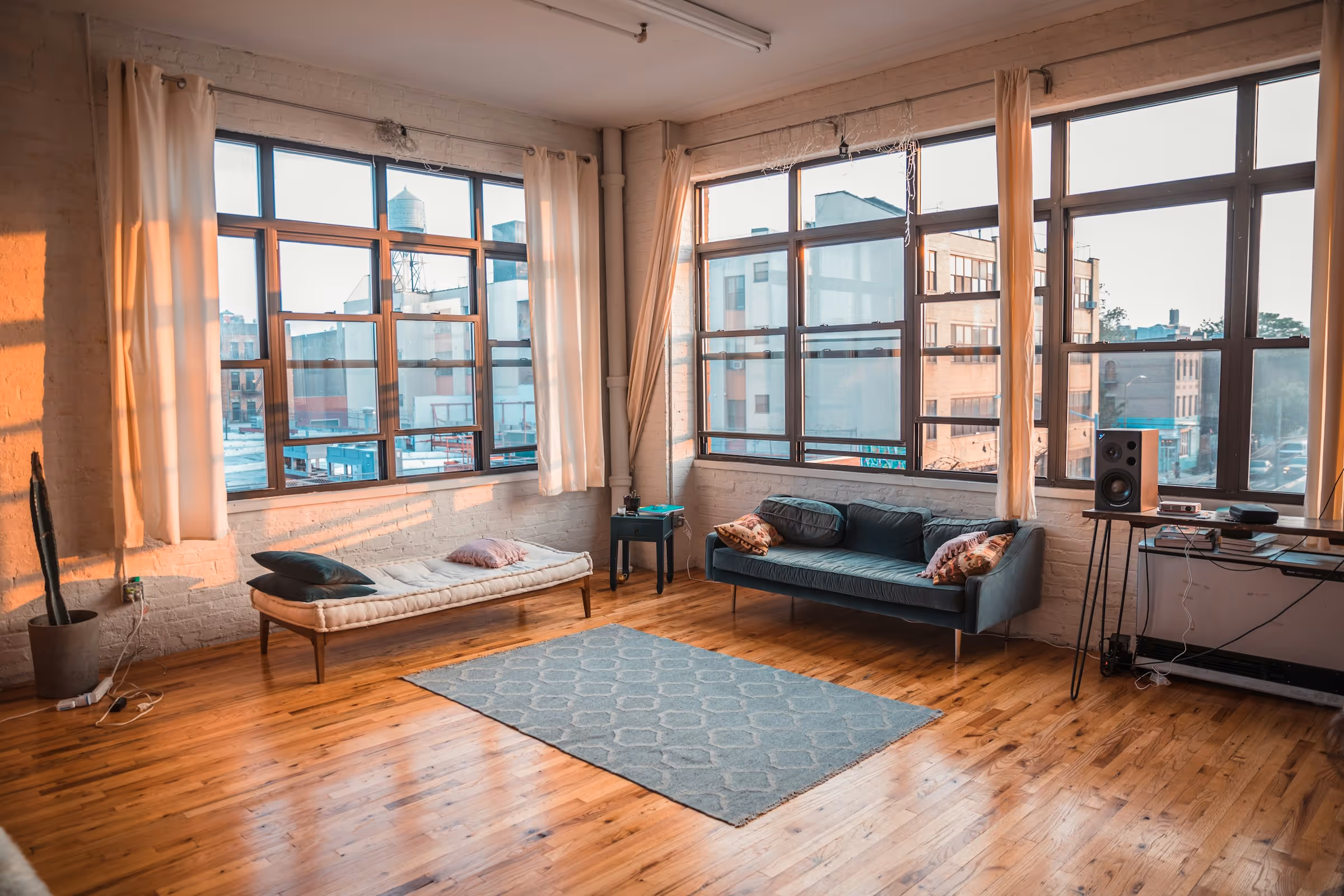 Bright loft room with sofas and large windows
