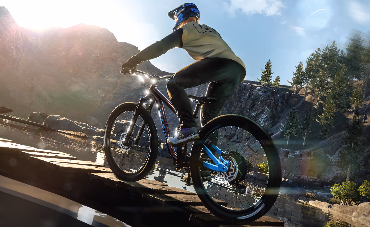 Mountain biker performing aerial trick against mountain backdrop