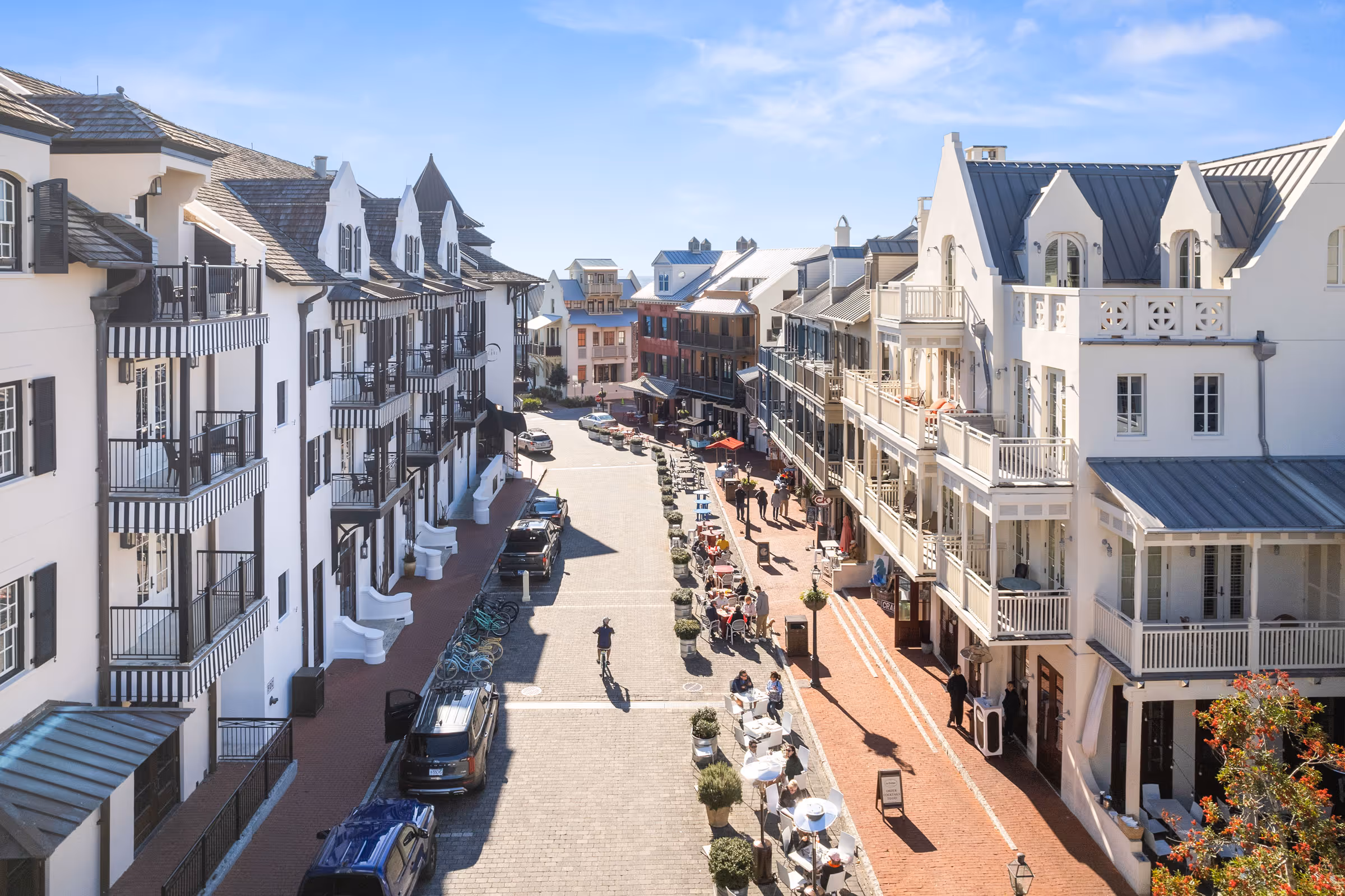 Emerald Coast lifestyle street view with colorful buildings and café seating
