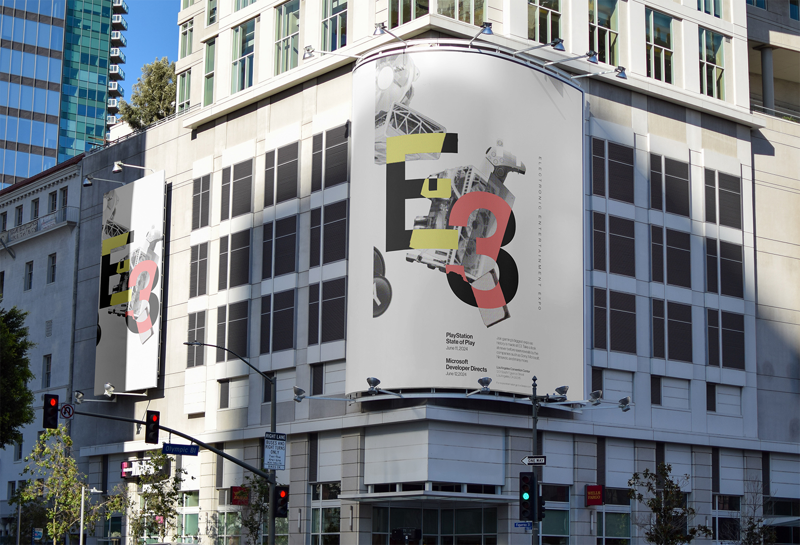 Large E3 banner on a building corner featuring electronic entertainment expo logo and event dates in an urban street setting.