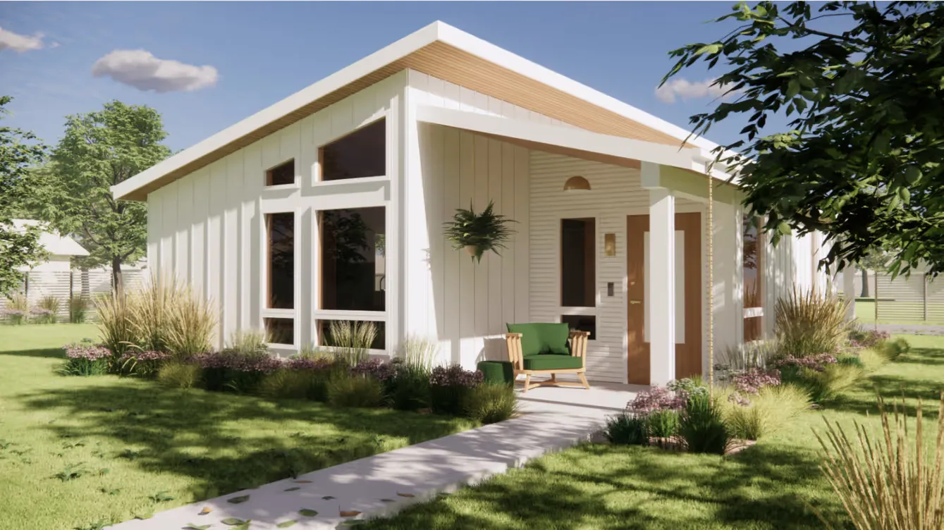 Modern white house with large windows, a wooden chair with green cushions on the porch, surrounded by green lawn and plants under a clear blue sky.