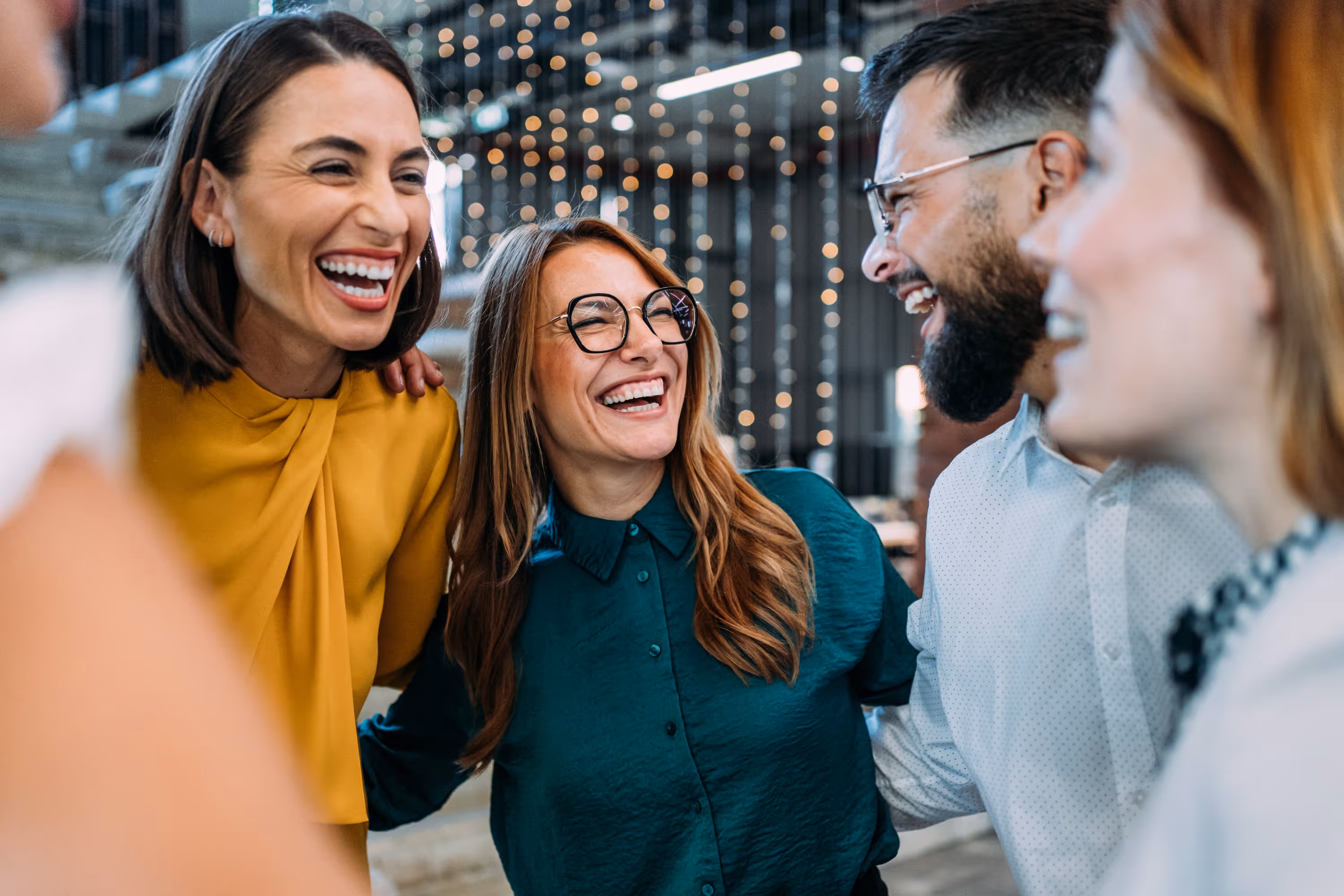 A group of people smiling in conversation