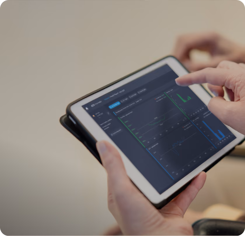 A clinician reviewing sleep data on a tablet