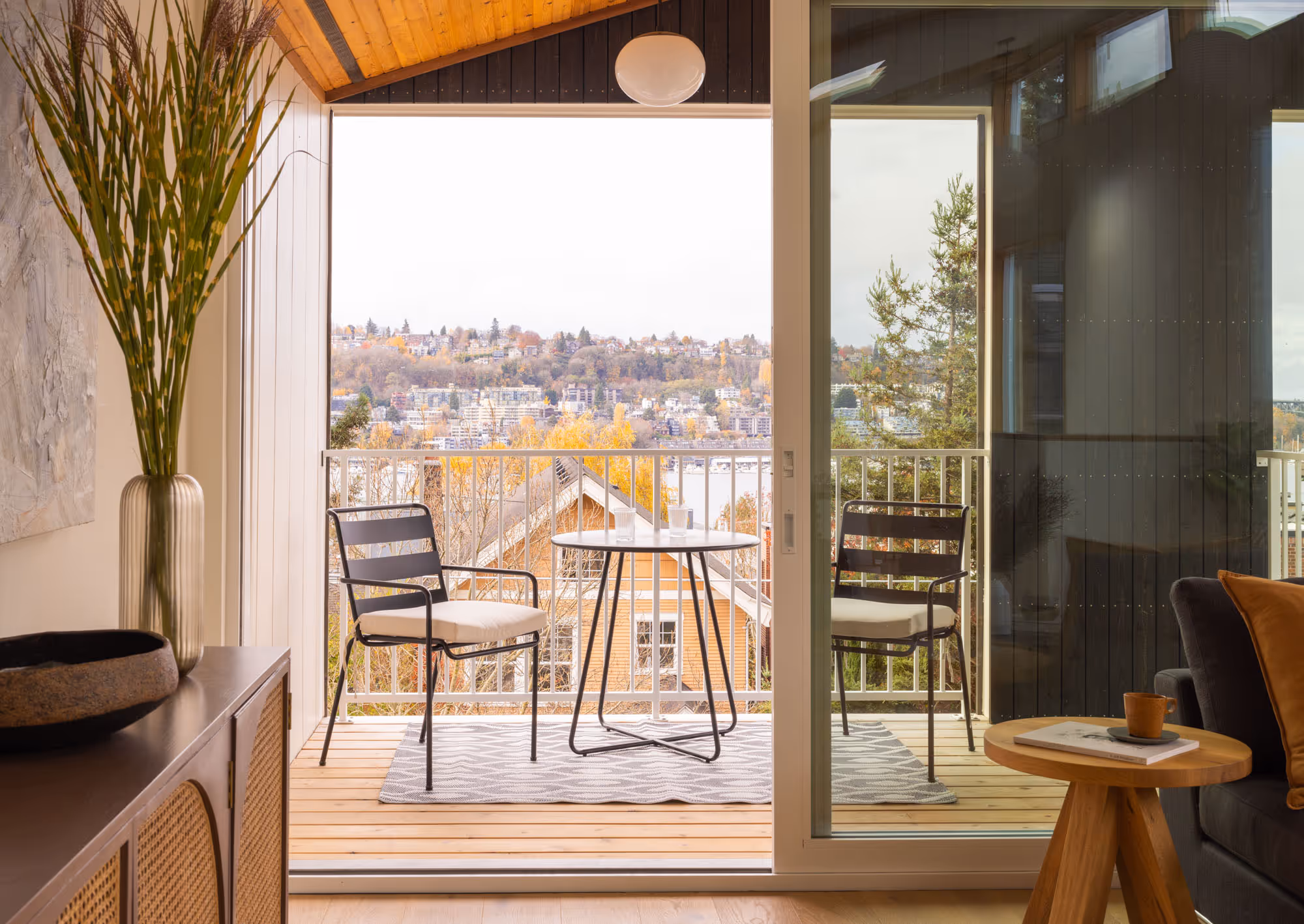 Looking from a living room through the balcony into a view over a developed area