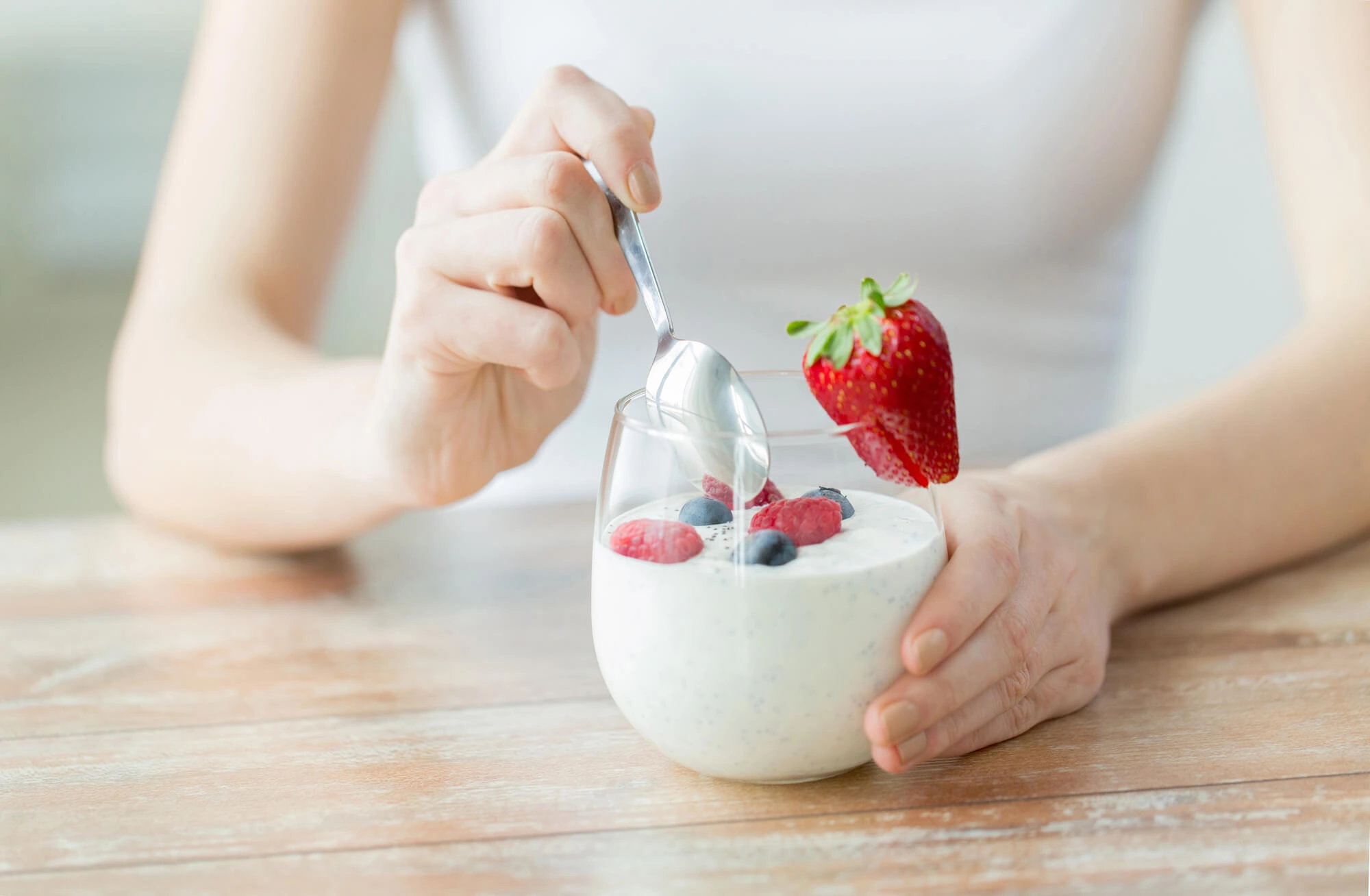 Woman eating yogurt after Tooth Extraction Bronx NY