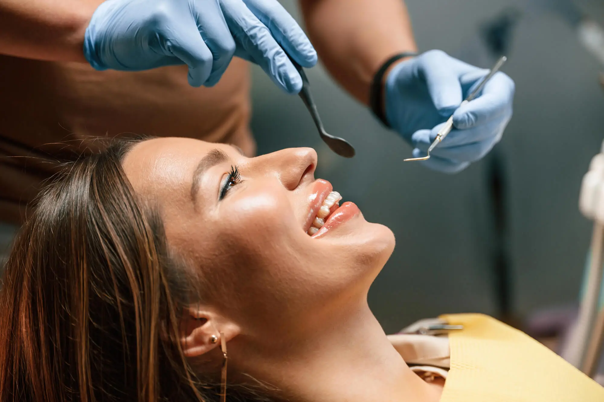 dentist checking dental crowns in Queens