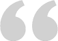 A gray vector image of a quotation mark.