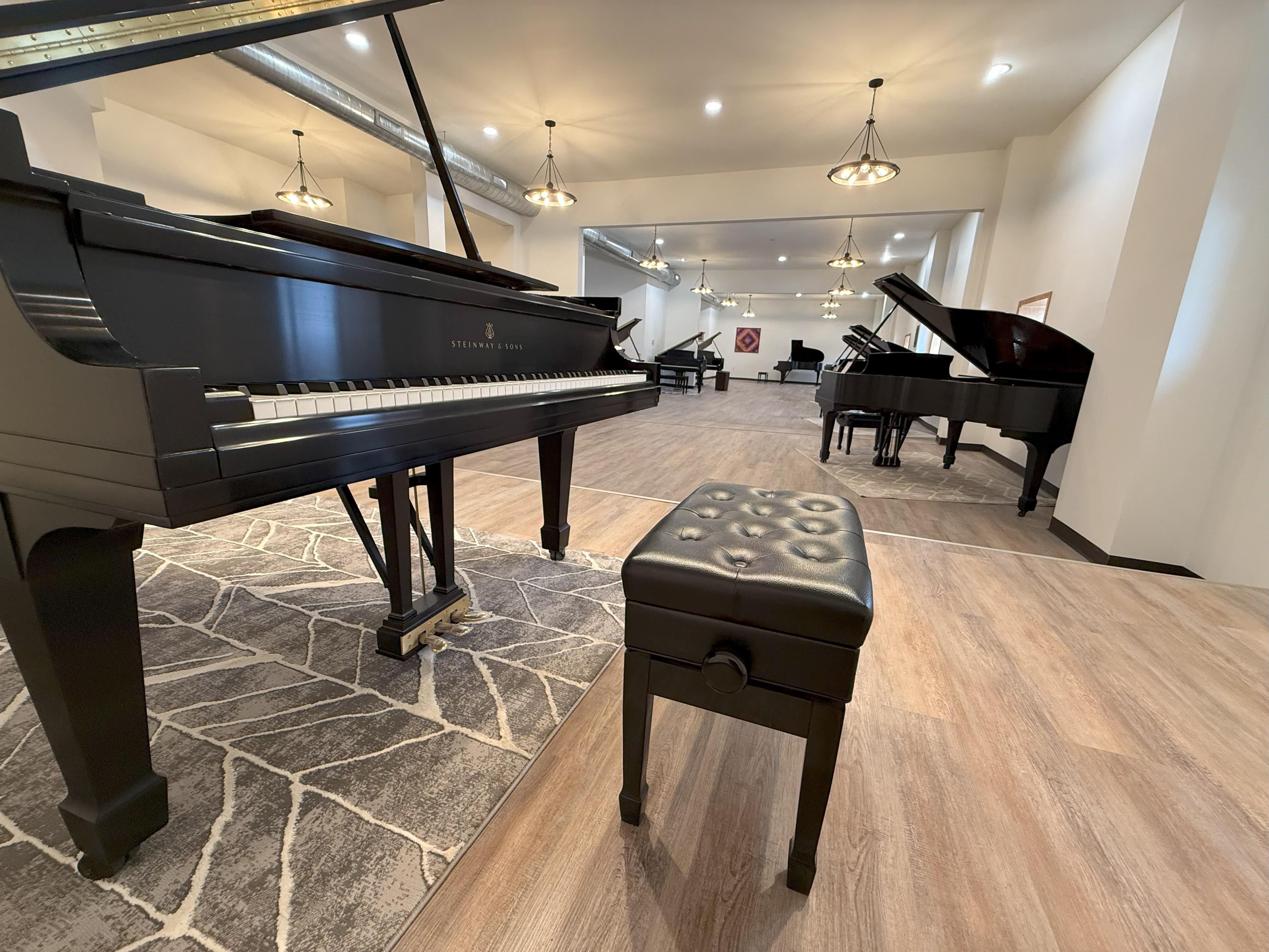 Piano with additional pianos in background