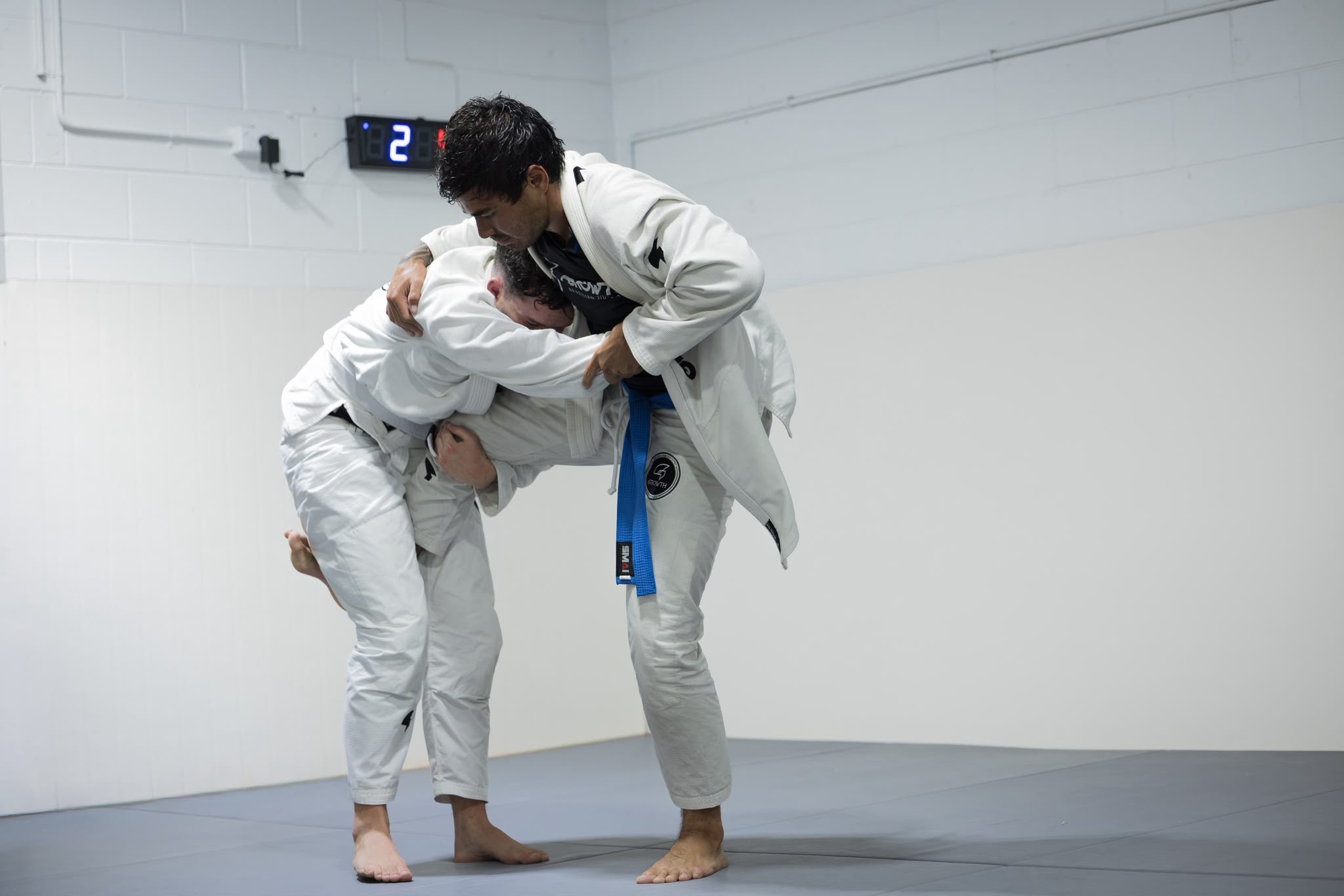 Adult BJJ students sparring in Gi at Growth BJJ Southport