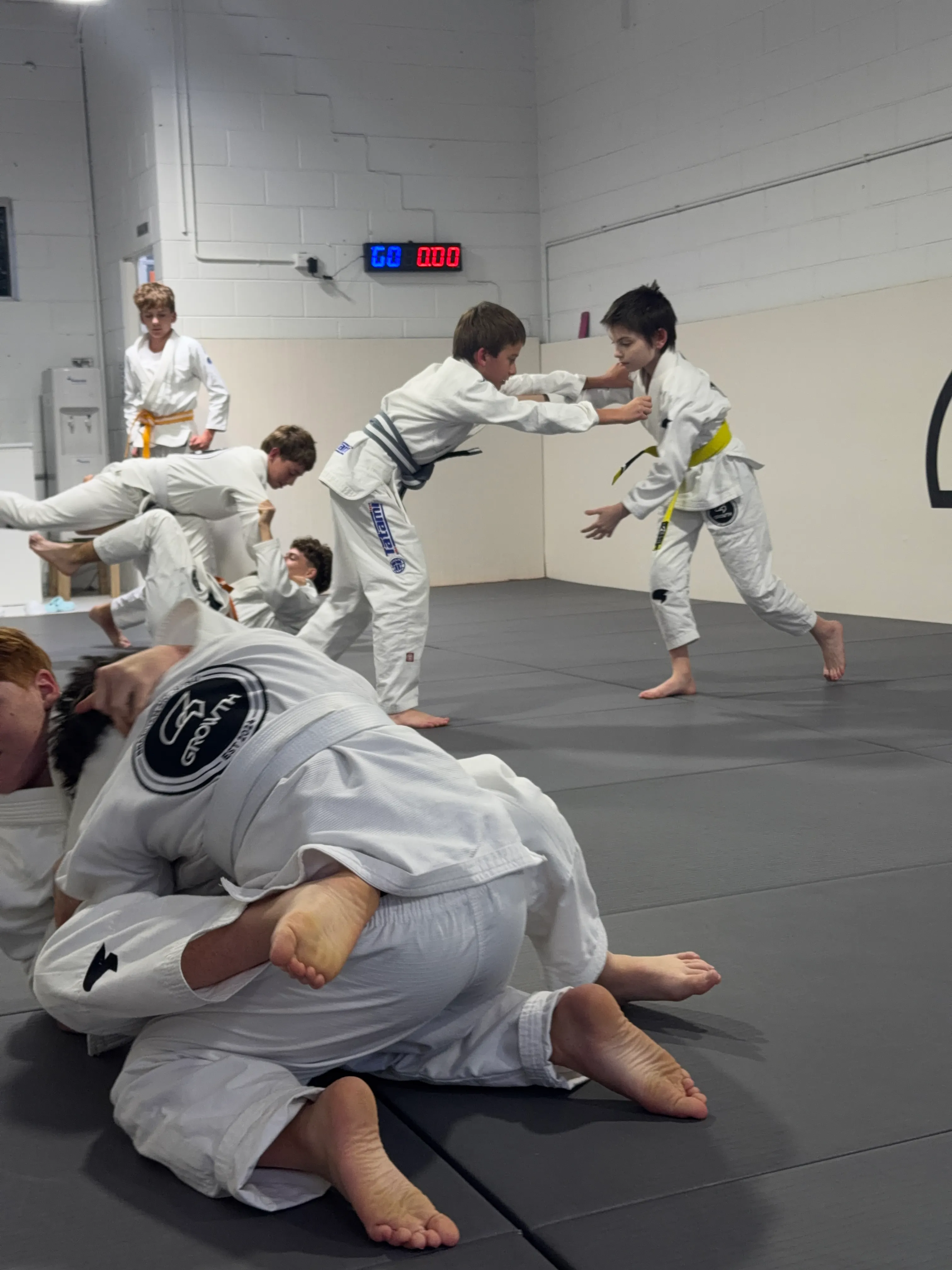 Teens sparring during Brazilian Jiu-Jitsu class at Growth BJJ
