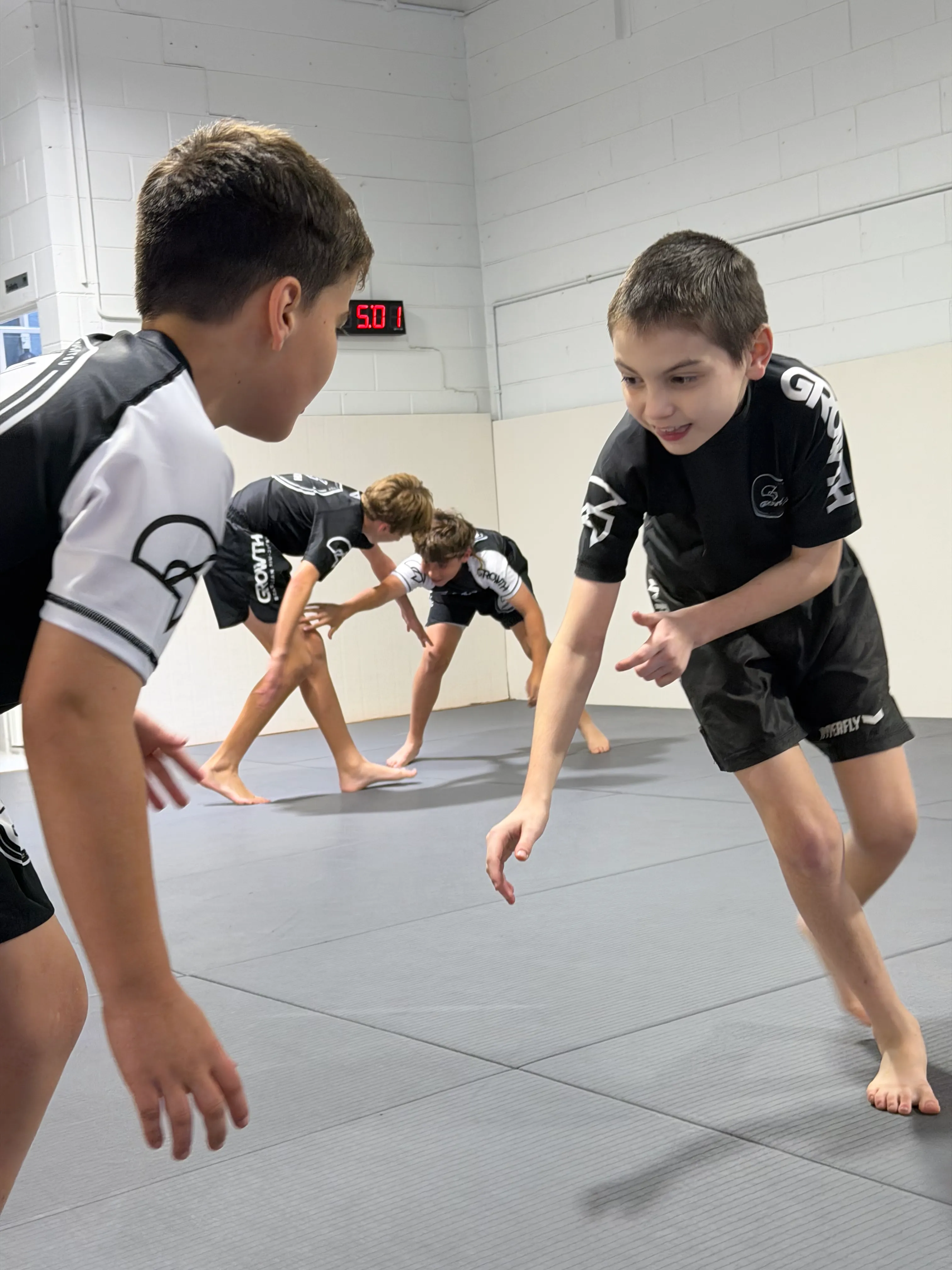 Teens training Jiu-Jitsu technique at Growth BJJ Southport