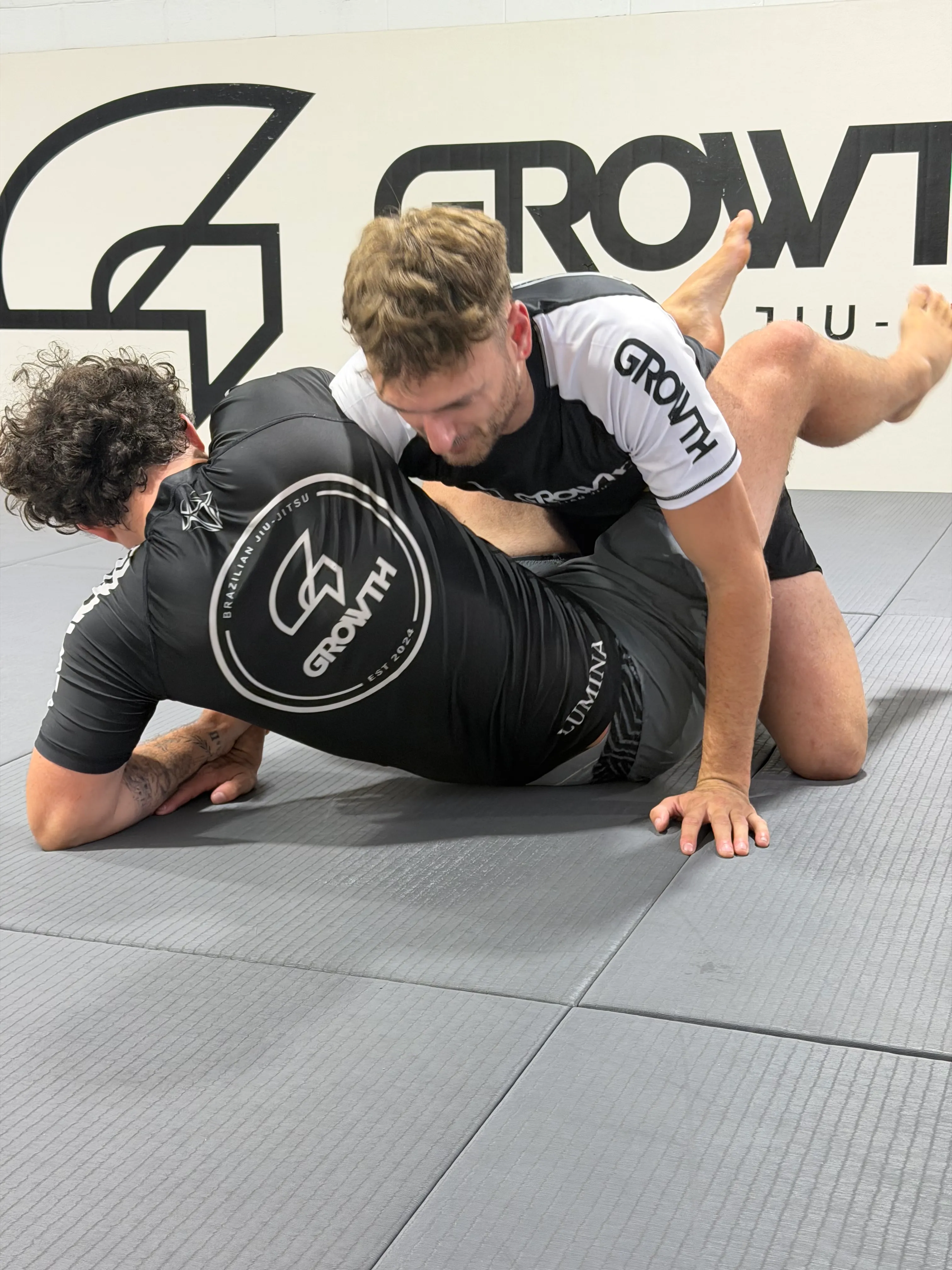 No-Gi Jiu-Jitsu students grappling on the mats at Growth BJJ