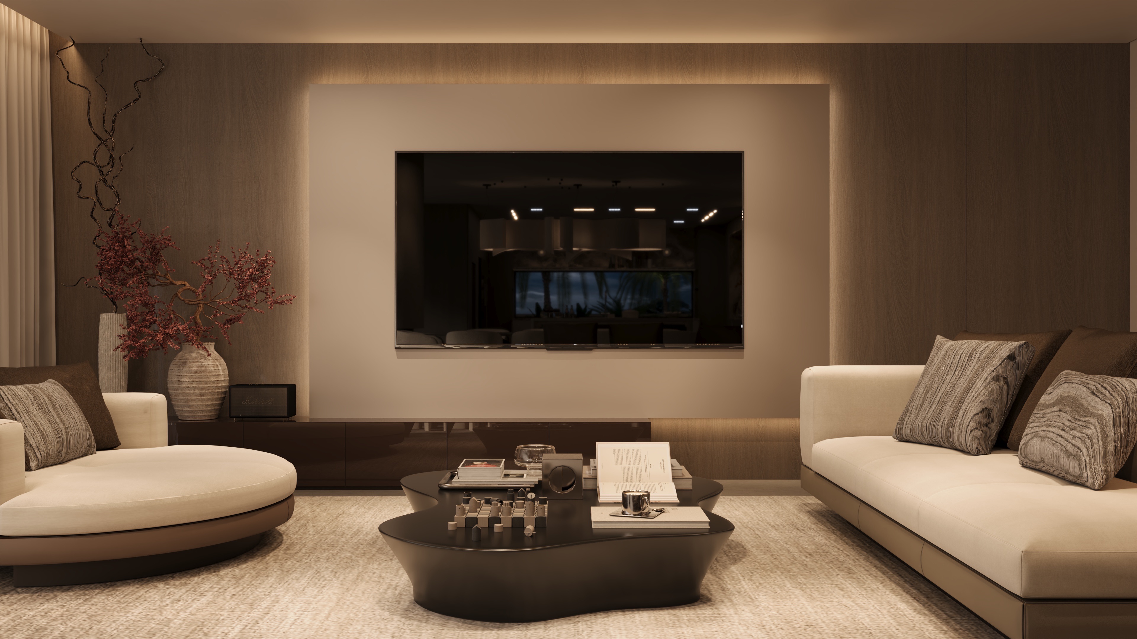 Sala de estar moderna com sofá bege, mesa de centro escura com livros e xícara, TV embutida na parede e vasos decorativos com galhos secos.