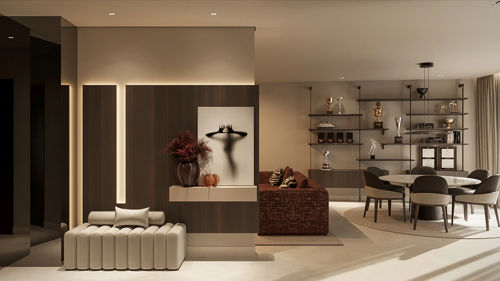 Sala de estar moderna com banco acolchoado bege, sofá marrom, estante com troféus, mesa de jantar redonda e quadro com sombra de uma figura humana.