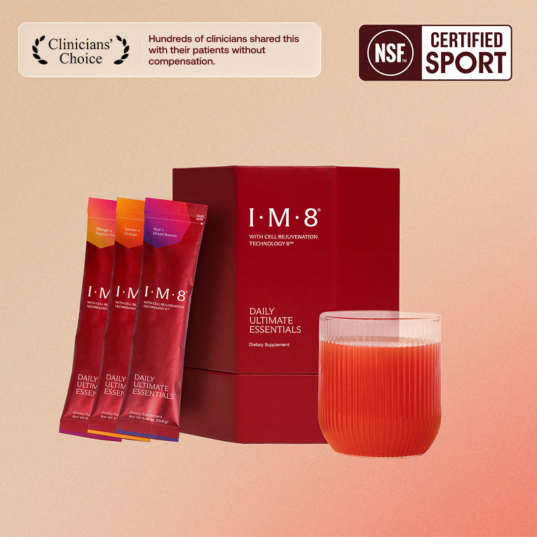 IM8 Daily Ultimate Essentials box with three flavour sachets and a glass of the prepared drink