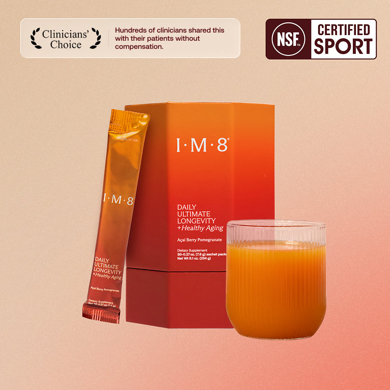 IM8 Daily Ultimate Longevity box with a sachet and a glass of the prepared drink
