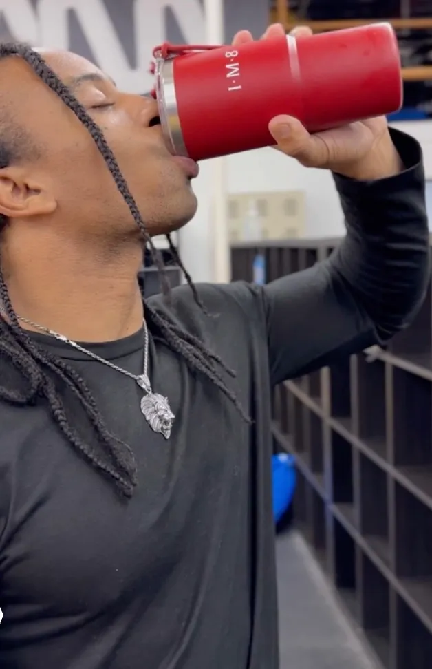 Fikshun drinking from an IM8 tumbler.