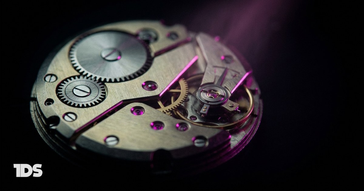 An open watch movement with magenta jewel bearings where one small gear drives a large wheel, representing a CEO content strategy that runs on 2 hours a week