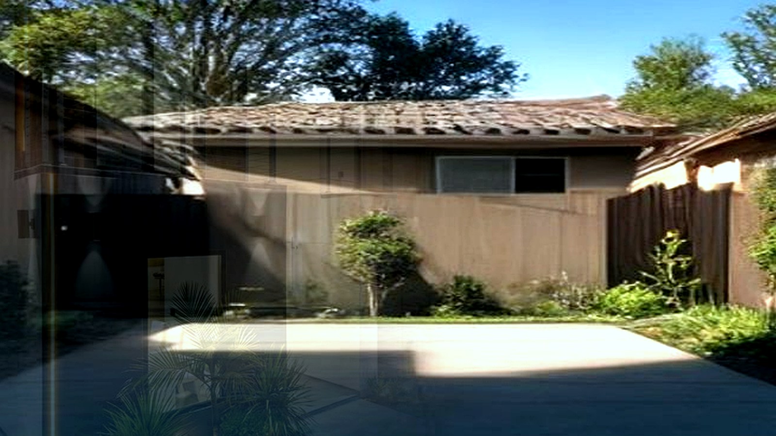 Photoreal Encino two-unit house with construction materials, no logos or text