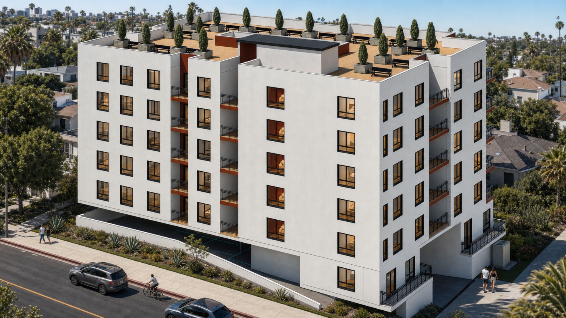 Rear corner view of the Fuller Avenue affordable housing building with upper-floor balconies, parking level, and rooftop amenity area