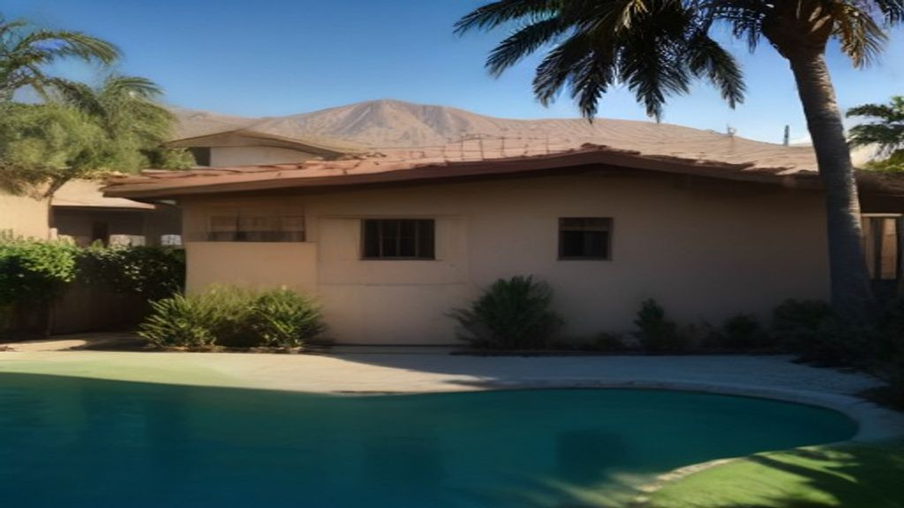 Late-afternoon Encino Valley backyard with a modest detached ADU cottage, palms, and San Fernando Valley hills — not a downtown high-rise