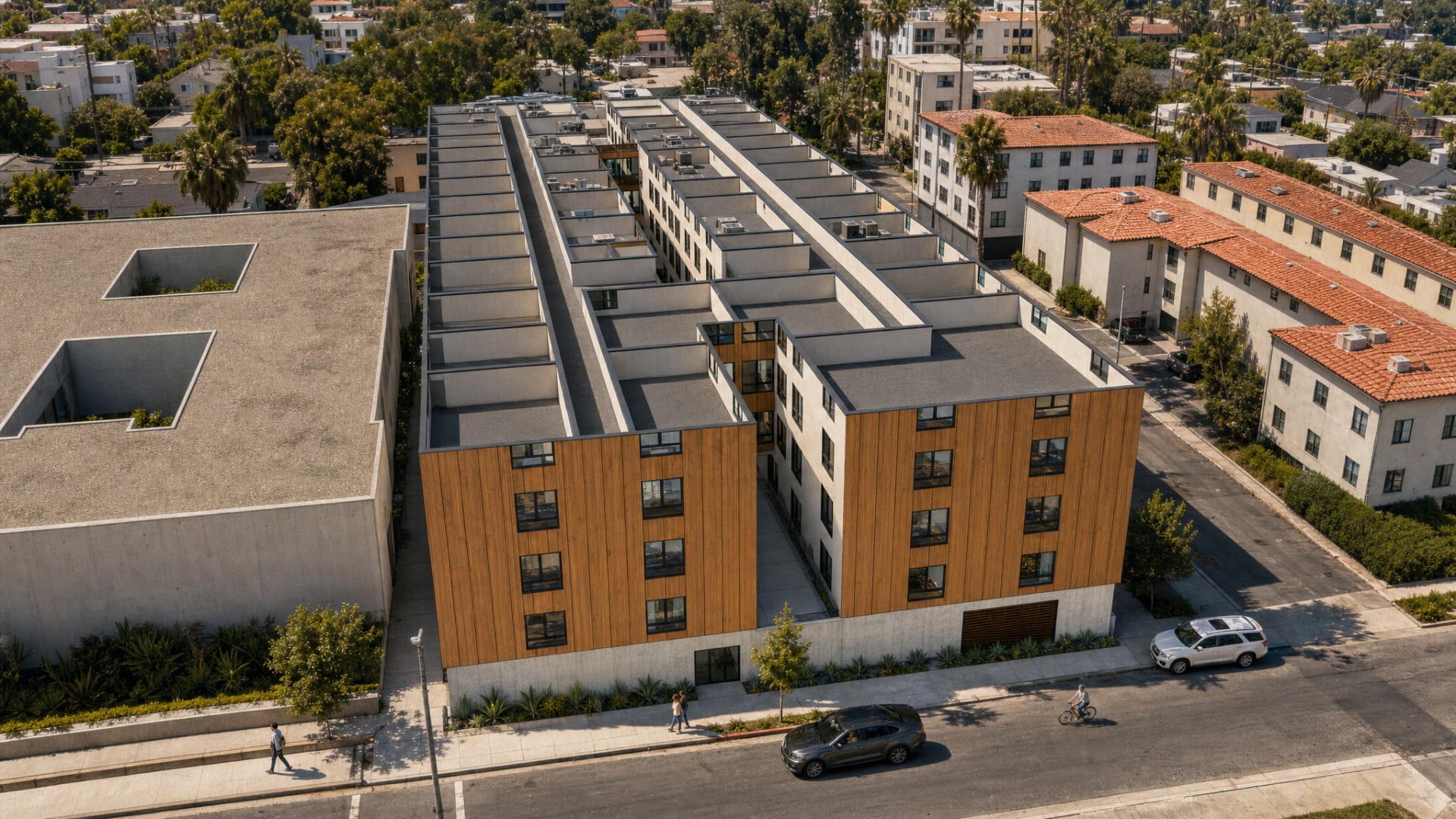 Elevated aerial rendering of the Orion Avenue affordable housing concept showing twin street-facing volumes and the full roof layout
