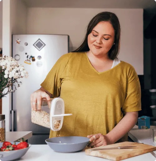 woman pouring cereal into a bowl