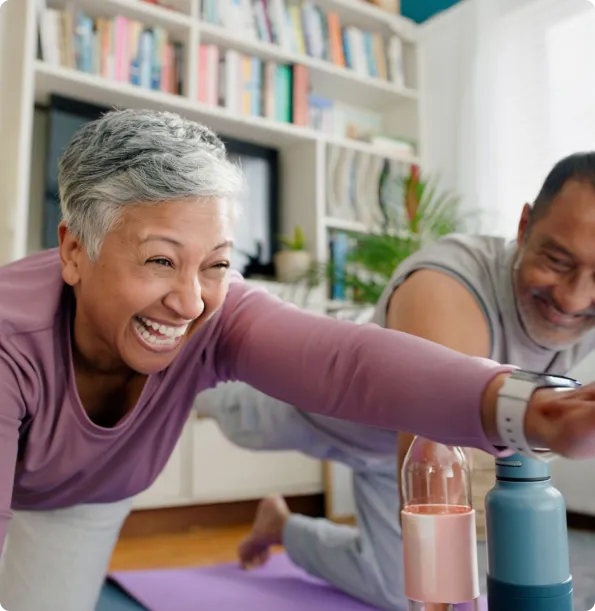 older woman and man performing yoga stretches