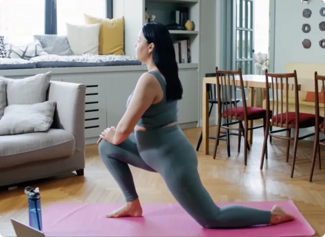 woman stretching on yoga mat