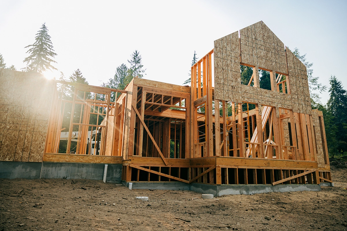 Wood-frame house under construction with exposed beams