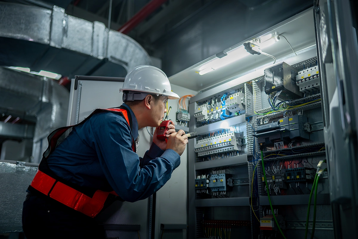 Electrician troubleshooting during emergency service call.