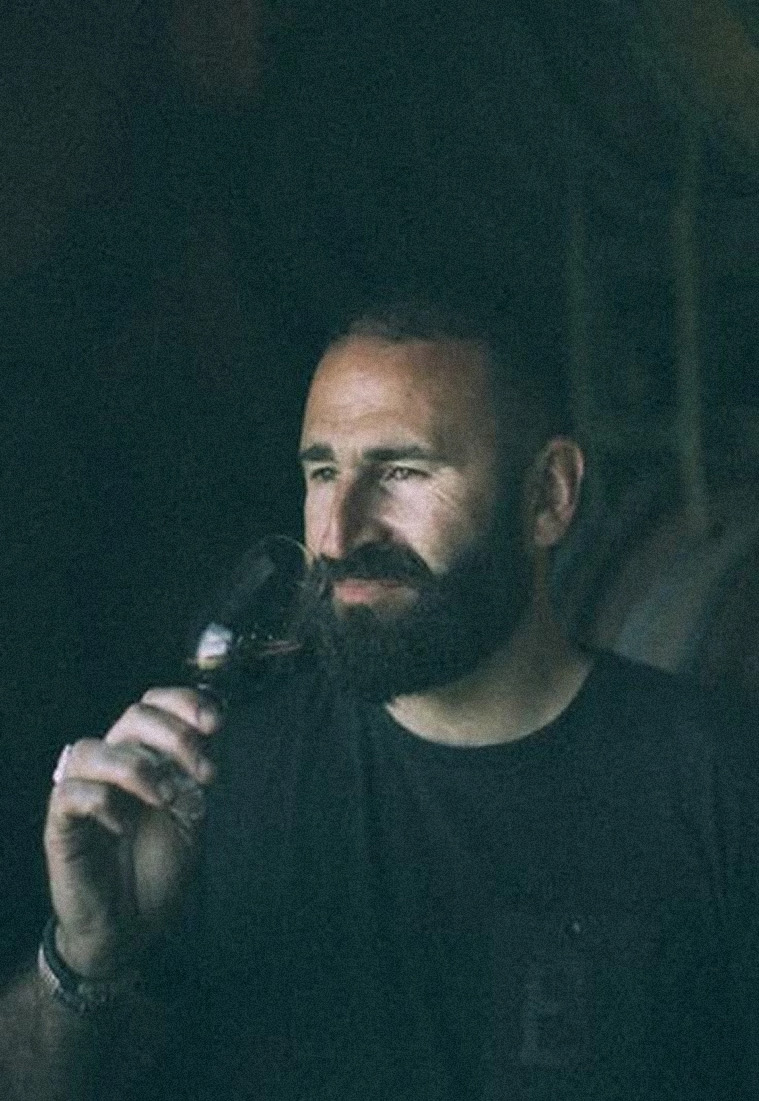 Andrew Bailey testing the quality of wine