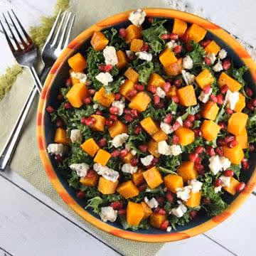 Kale Salad with Butternut Squash in an orange bowl.