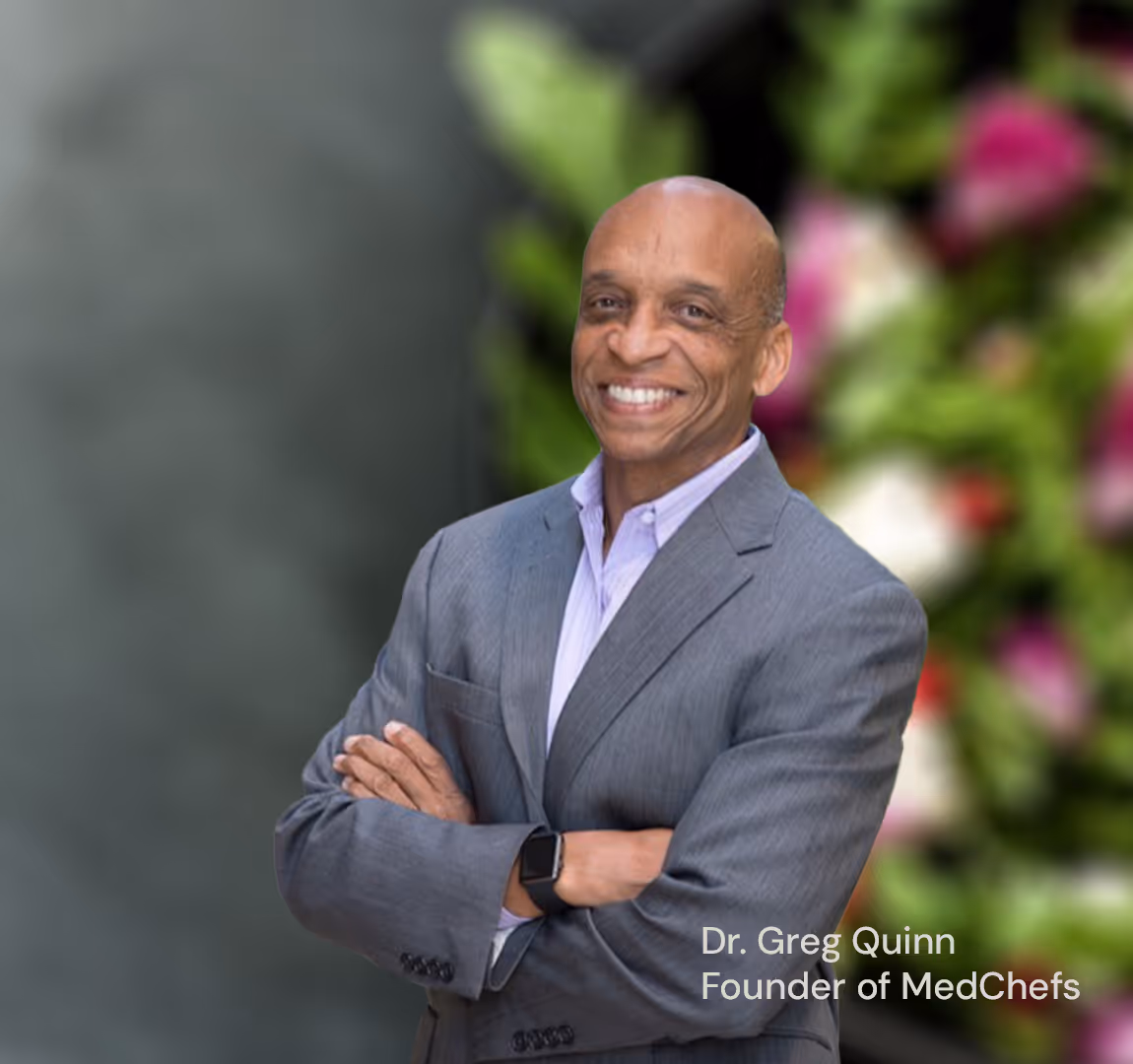 Dr. Greg Quinn smiling with blurred salad background.