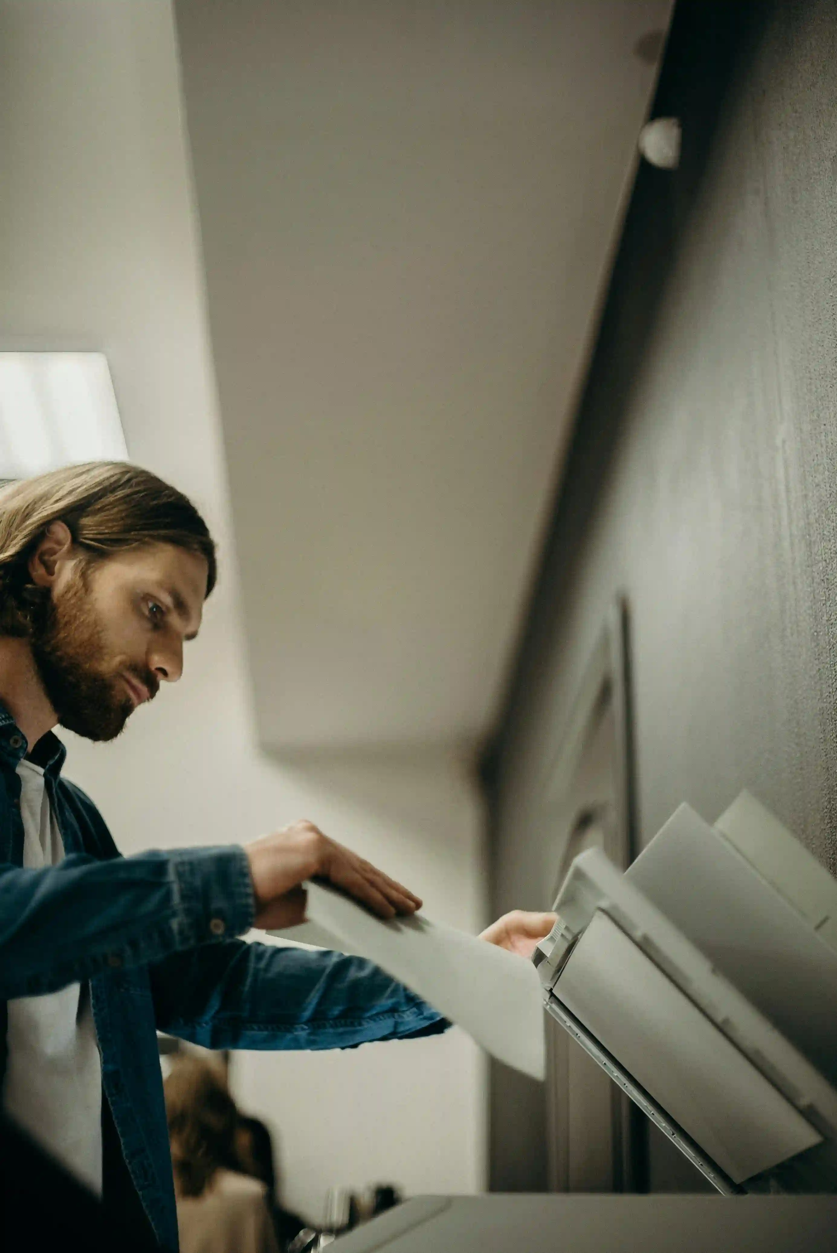 A man making a photocopy at a copier.