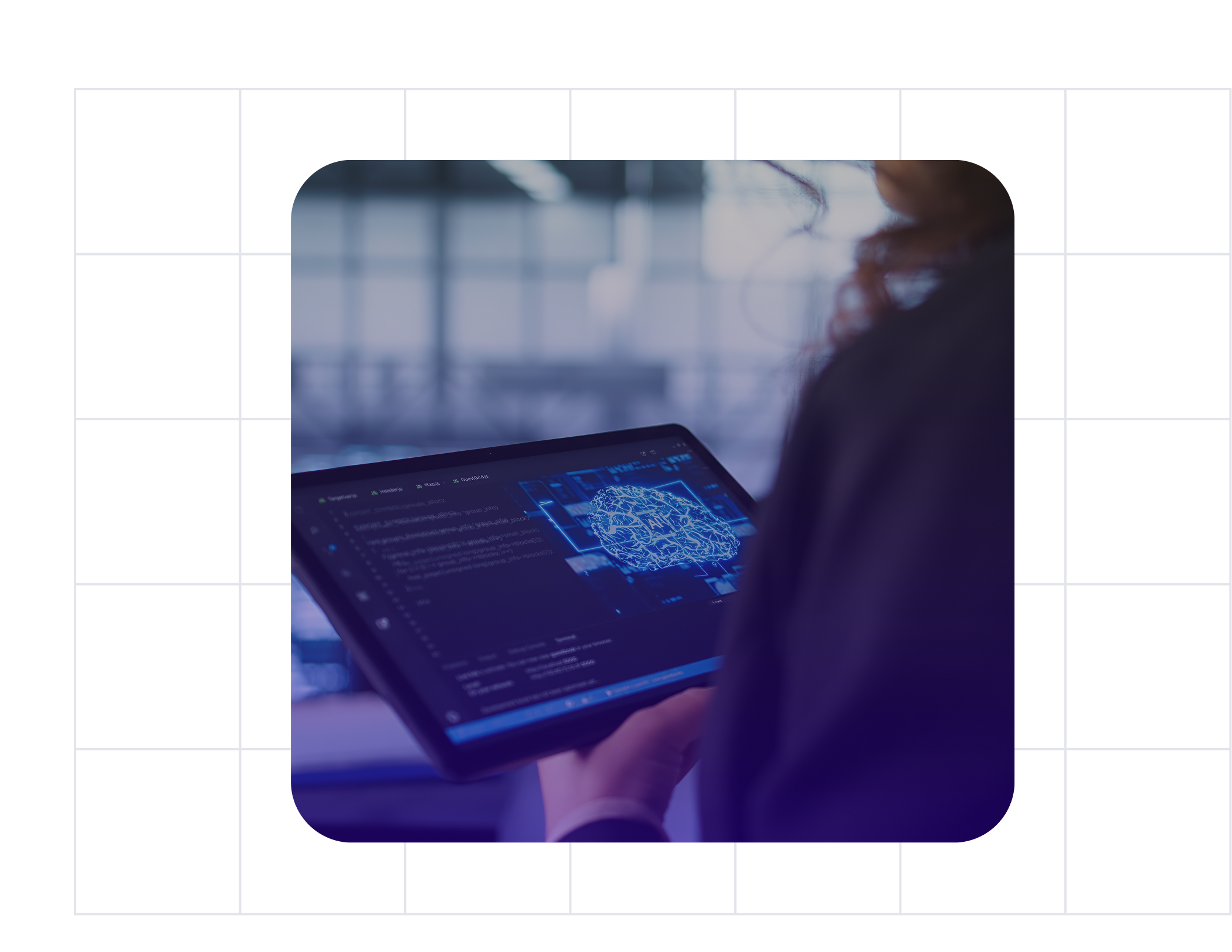 Person holding a tablet displaying a digital brain graphic and code in a modern workspace.