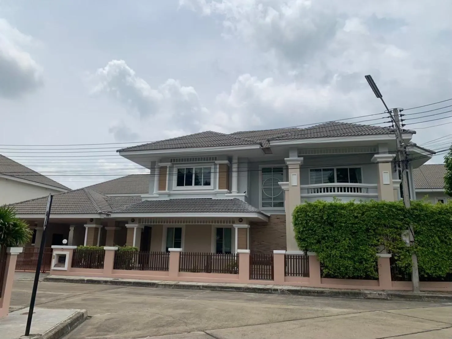 Roadside Image of this fully renovated 4-bed, 5-bath house with 2 kitchens in Chiang Mai's Laguna compound