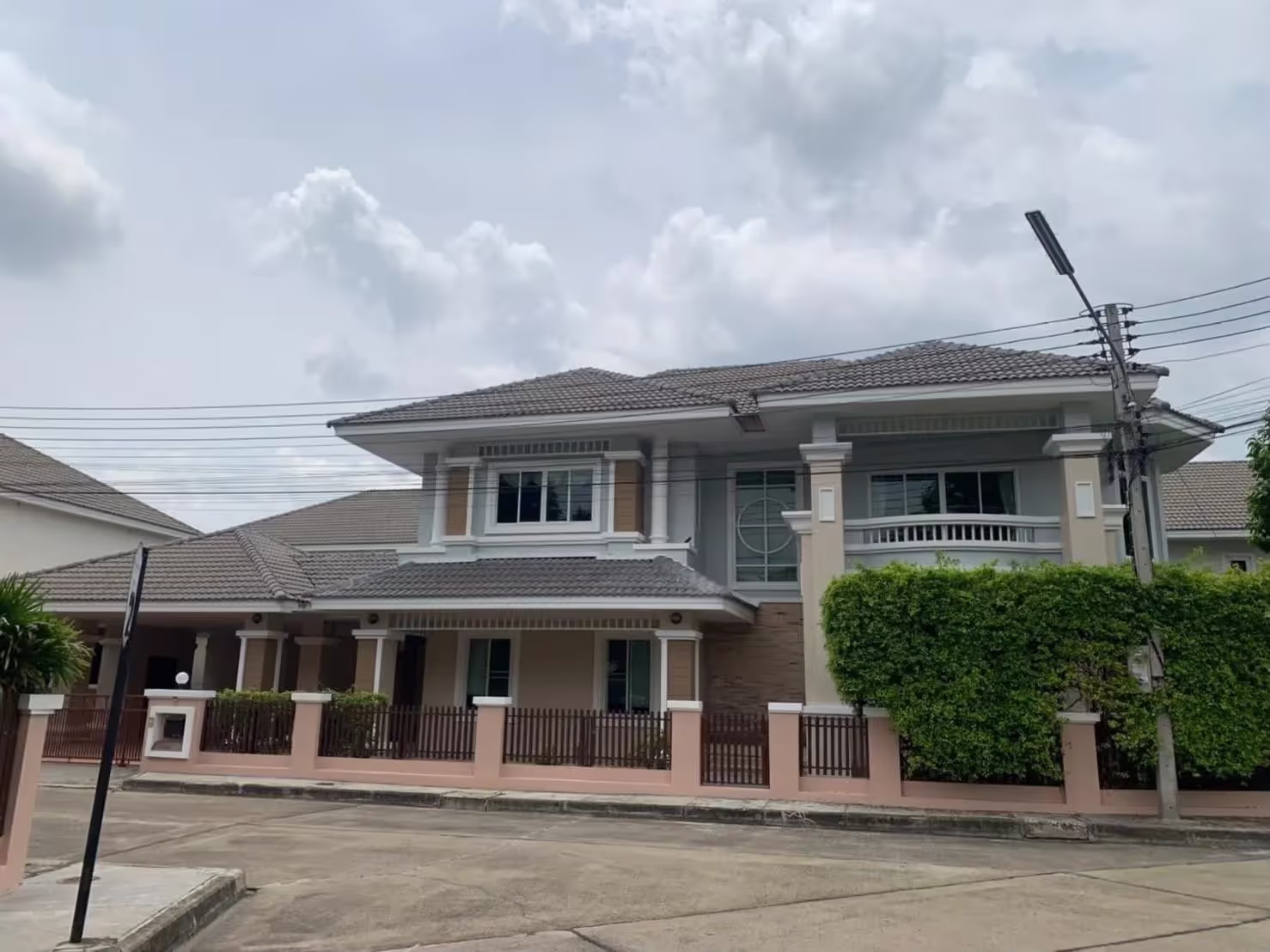 Roadside Image of this fully renovated 4-bed, 5-bath house with 2 kitchens in Chiang Mai's Laguna compound