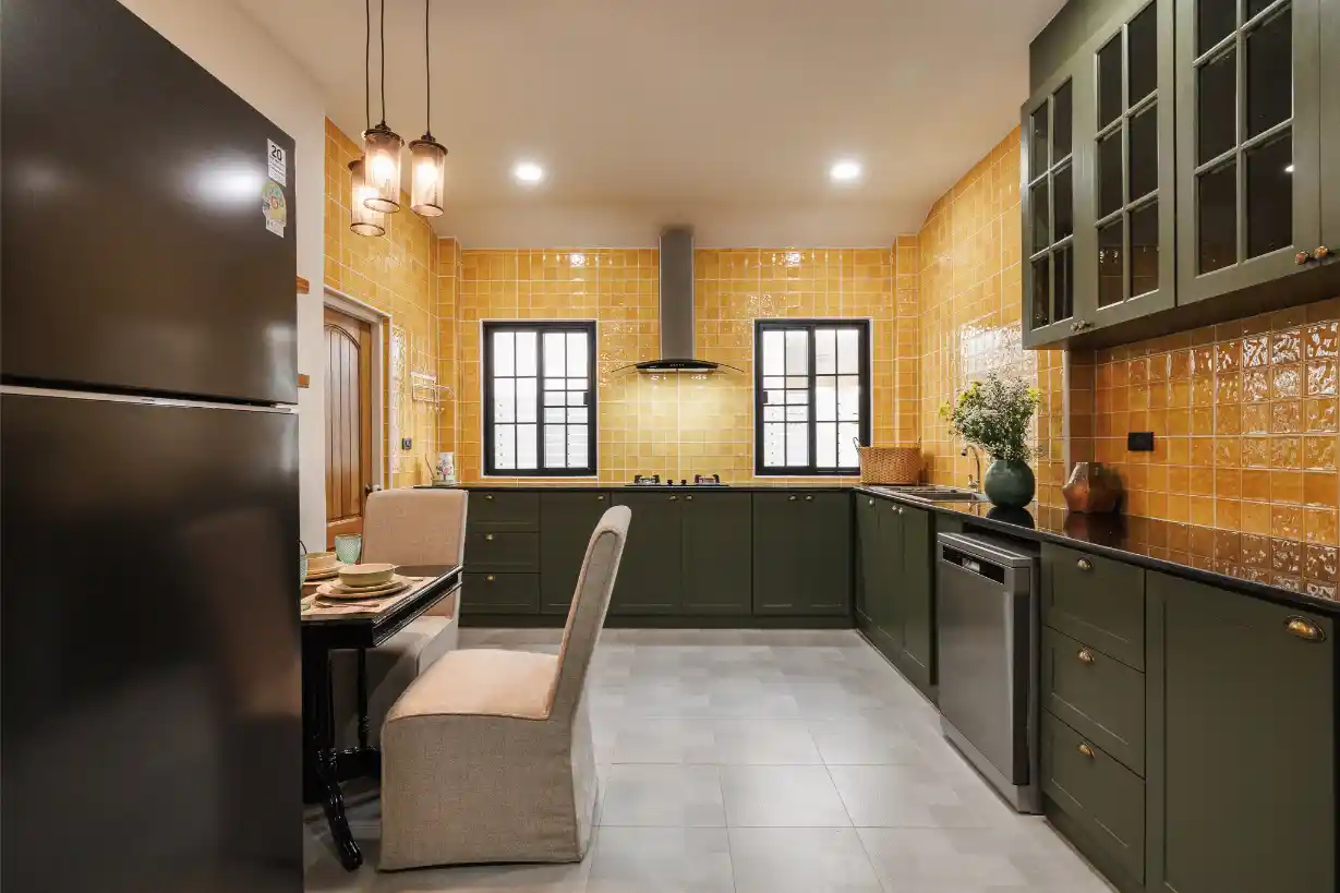 Wide view of the modern kitchen, showing the large refrigerator and eat-in dining table.