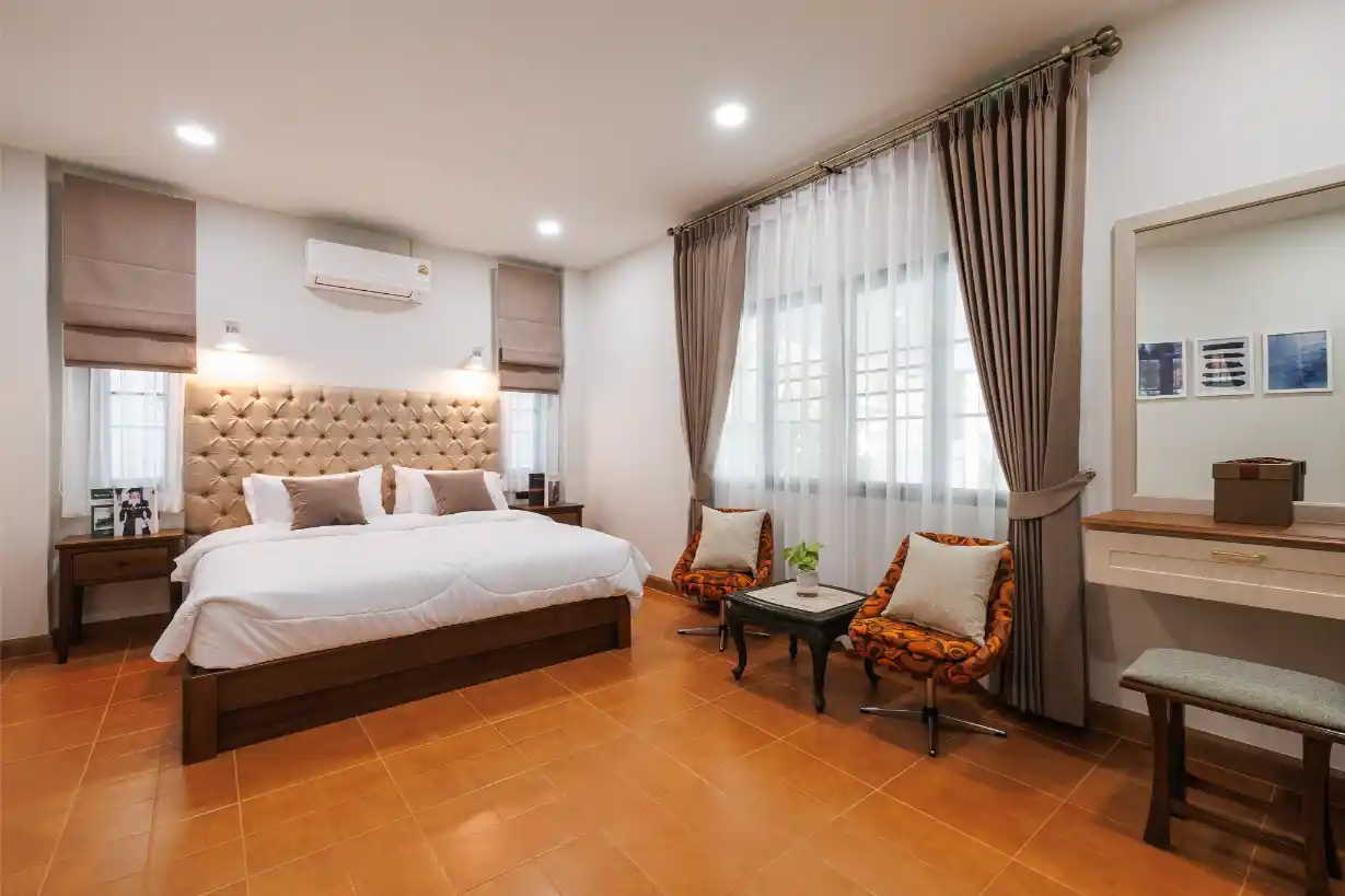 One of five bedrooms in the furnished San Sai home, with a king bed and sitting area.