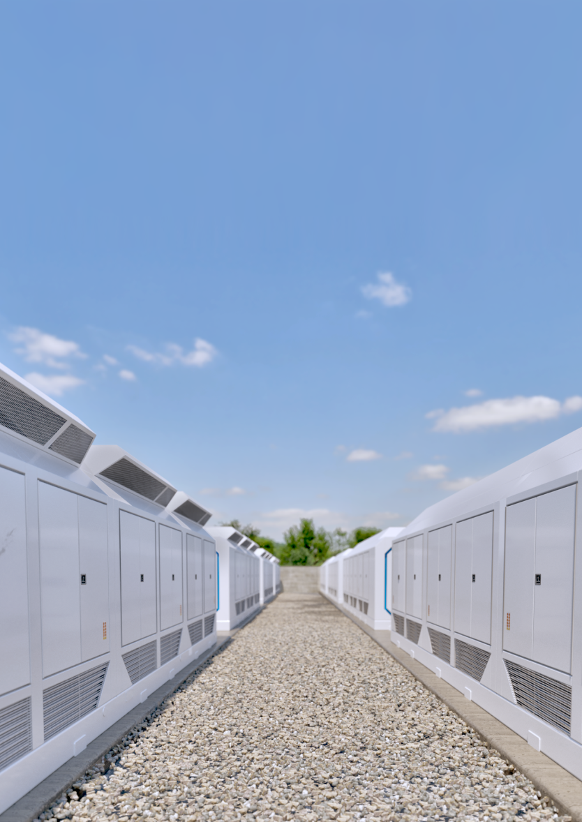 Two rows of white outdoor electrical cabinets along a gravel path under a blue sky with scattered clouds.