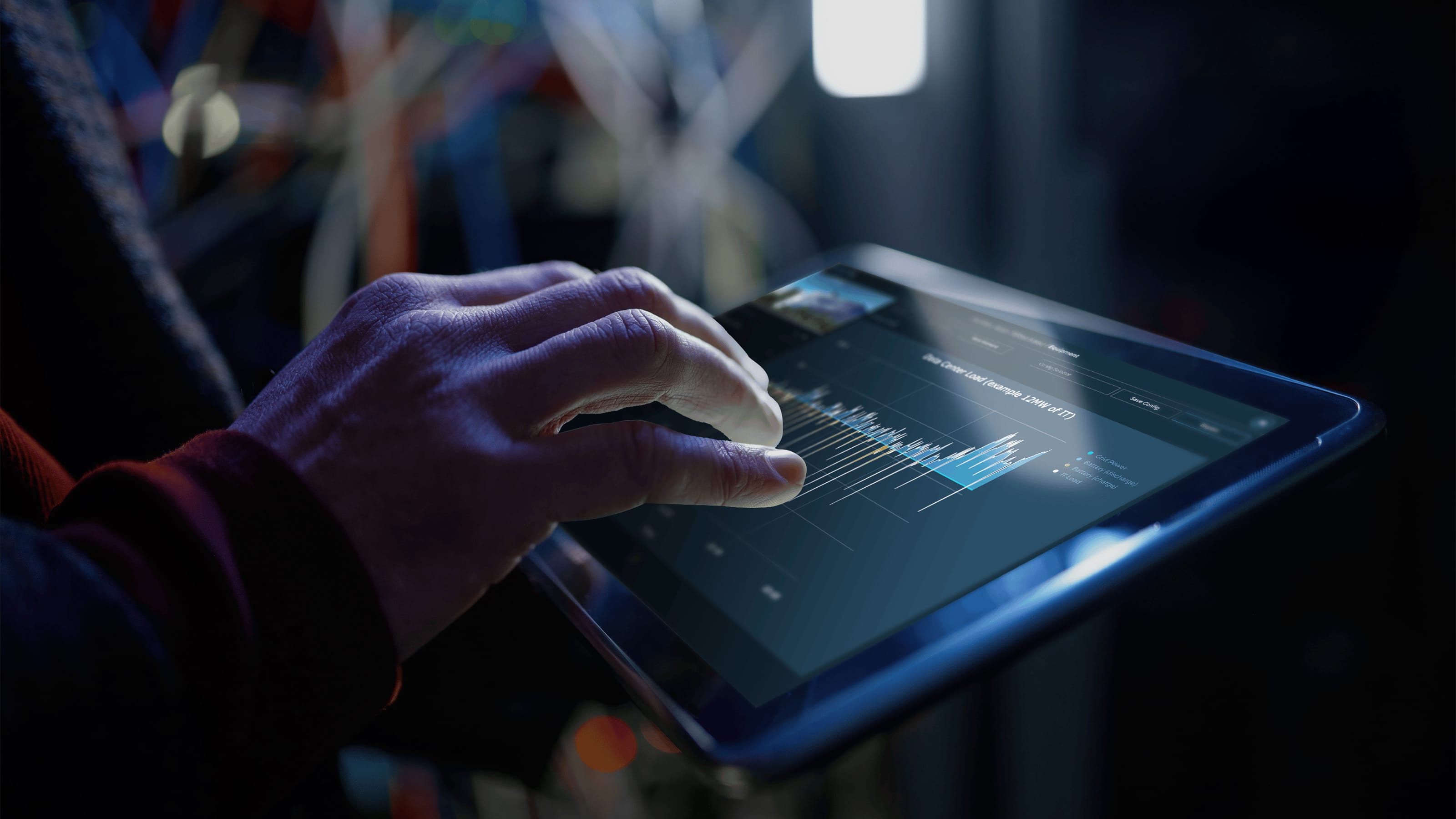 Long corridor of server racks illuminated with blue LED lights inside a modern data center.