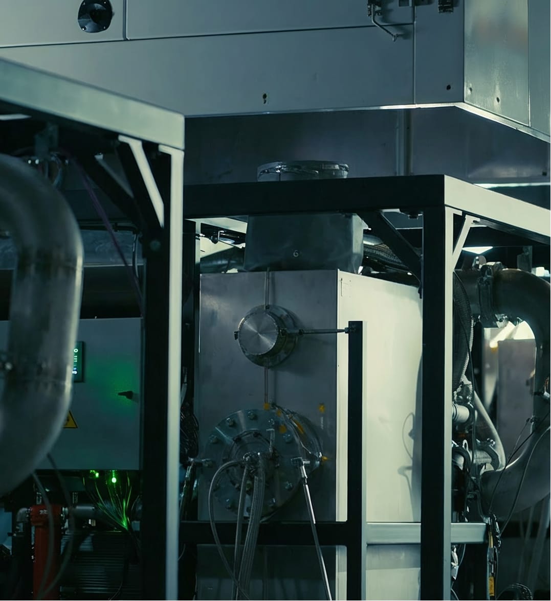 Outdoor installation of white, modular TurboCell energy storage units on gravel under a blue sky.