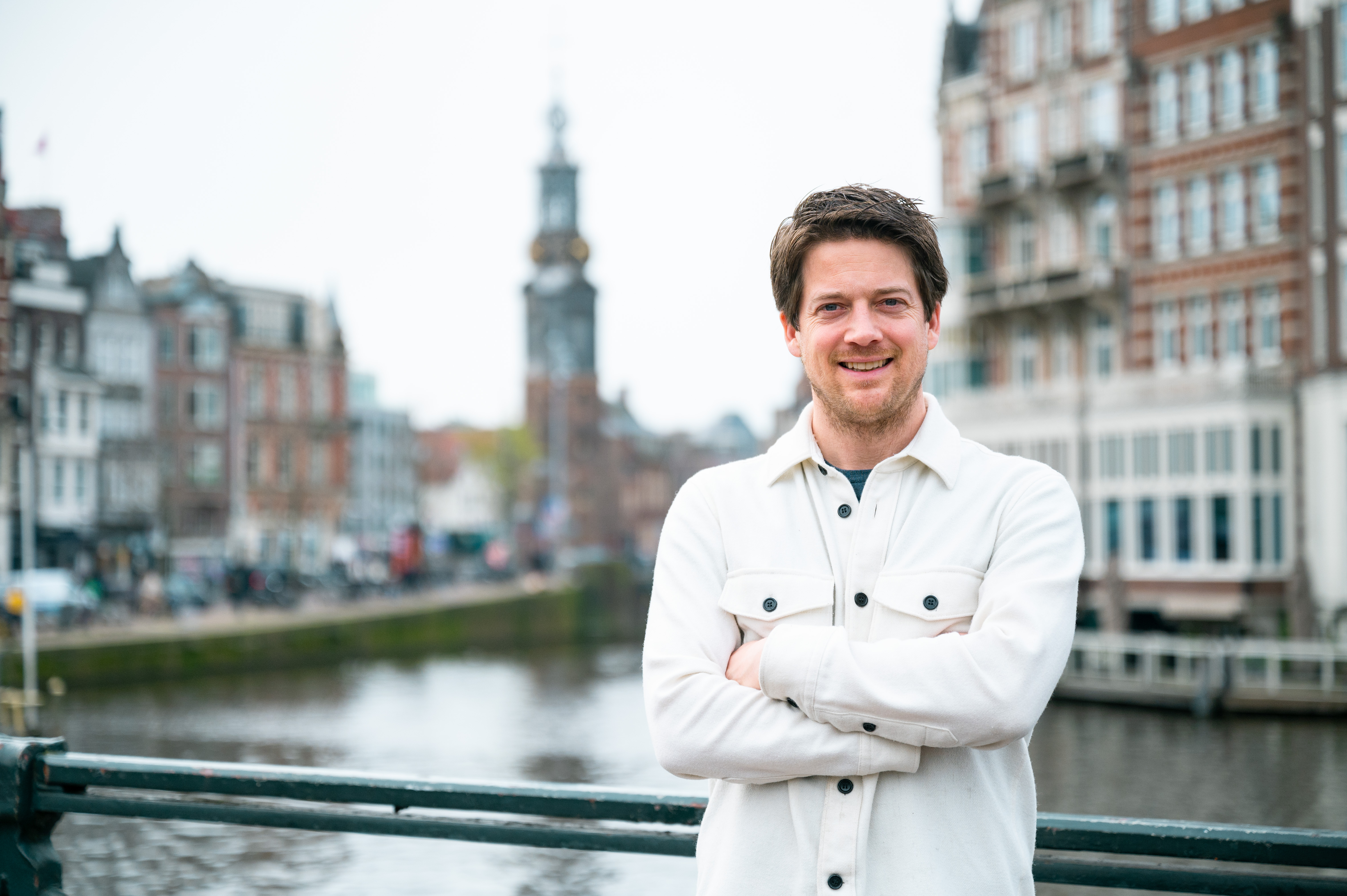 Man staat lachend op brug