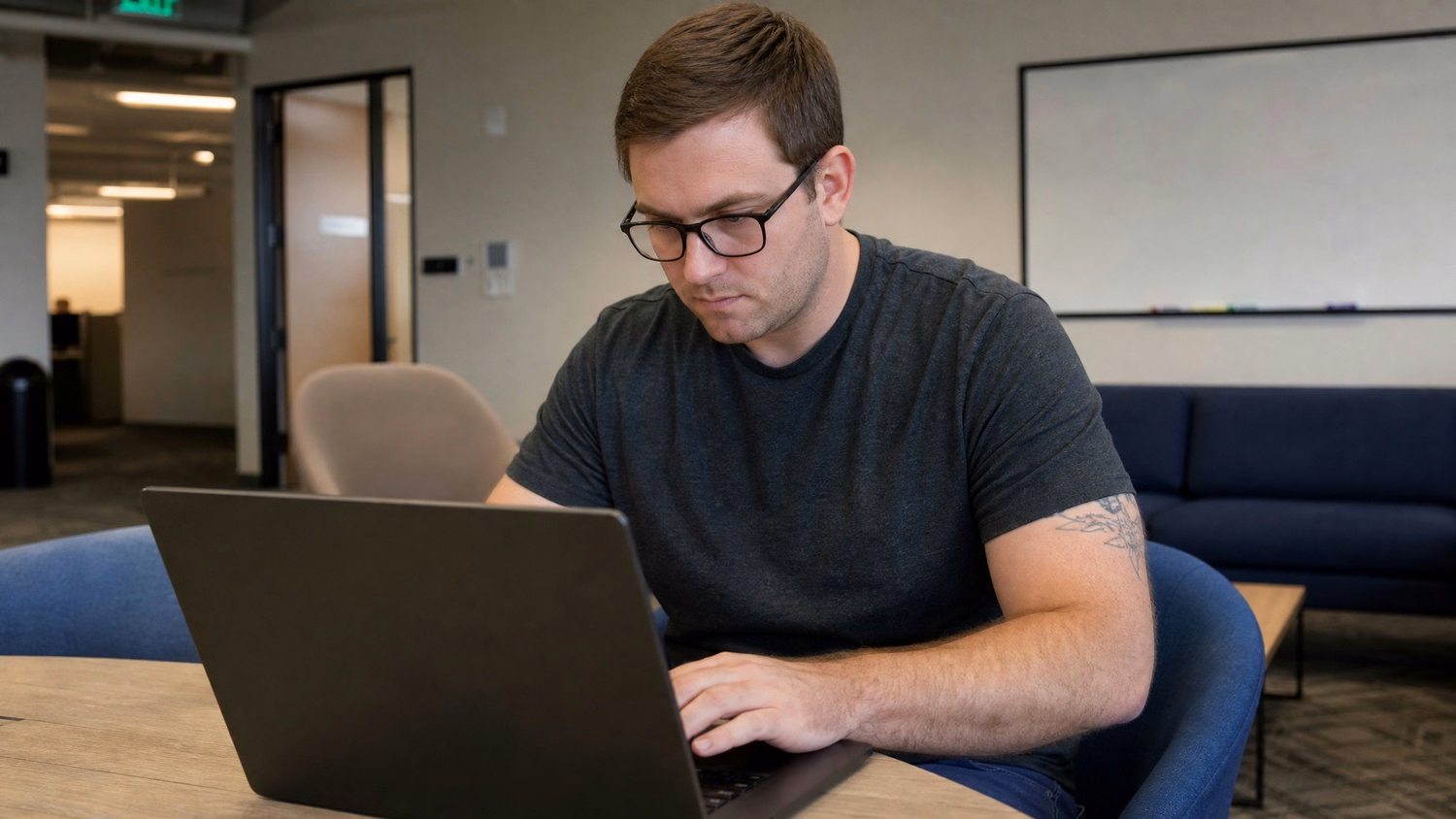 LOUNGE AREA LAPTOP An IT professional  one person working on a laptop in a ca